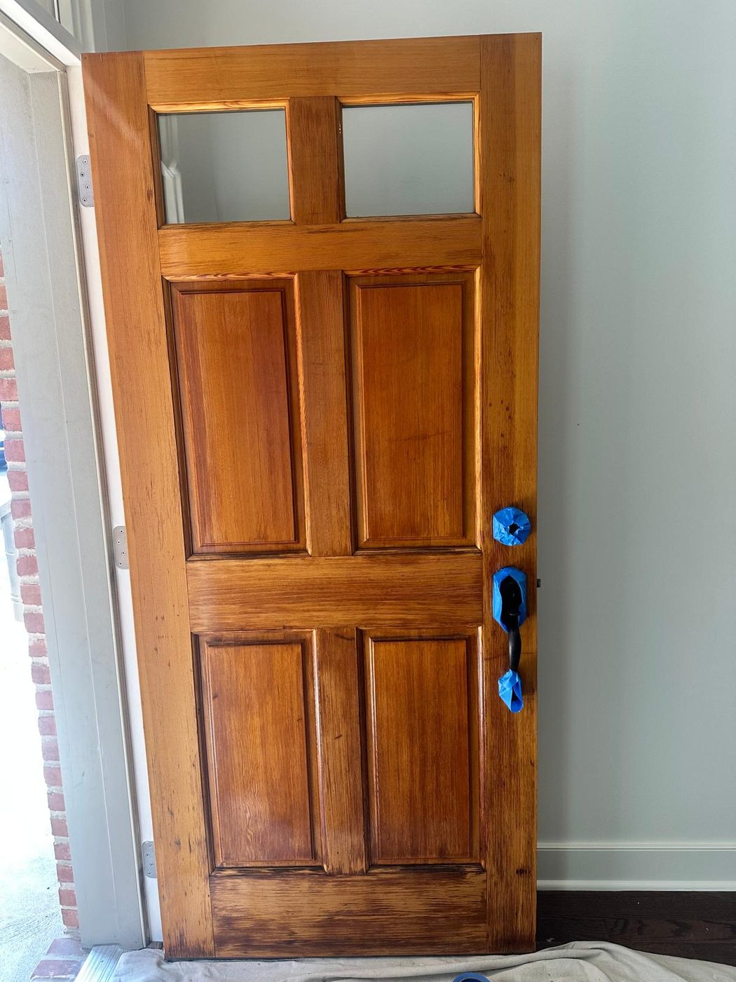 Restored solid wood entry door with fresh stain